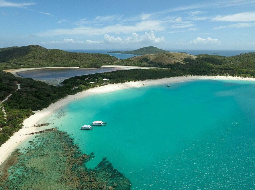Crystal clear turquoise waters and white sand at Flamenco Beach in Culebra, your final destination after taking a taxi to Flamenco Beach departure points.