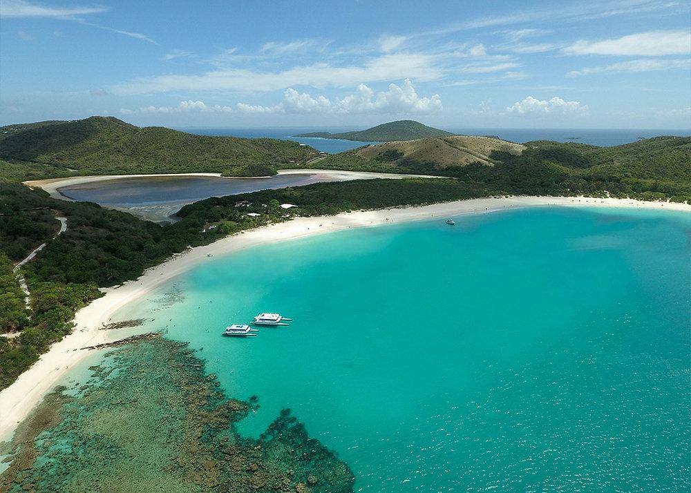 Crystal clear turquoise waters and white sand at Flamenco Beach in Culebra, your final destination after taking a taxi to Flamenco Beach departure points.